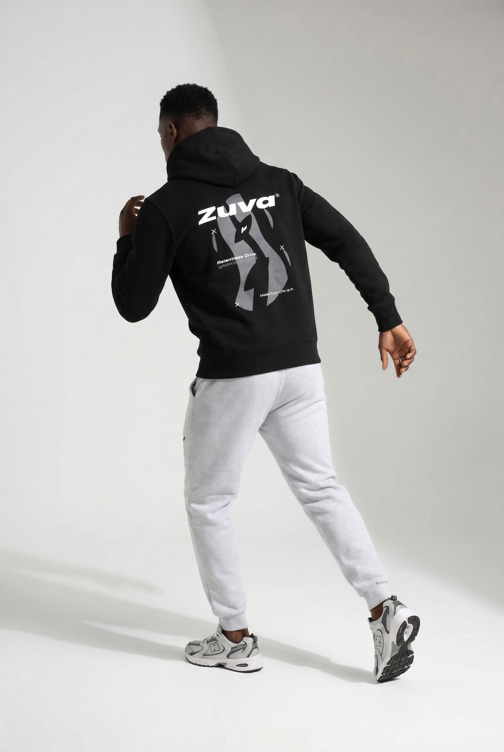 Zuva Black Hoodie back graphic Relentless Drive puff print on model