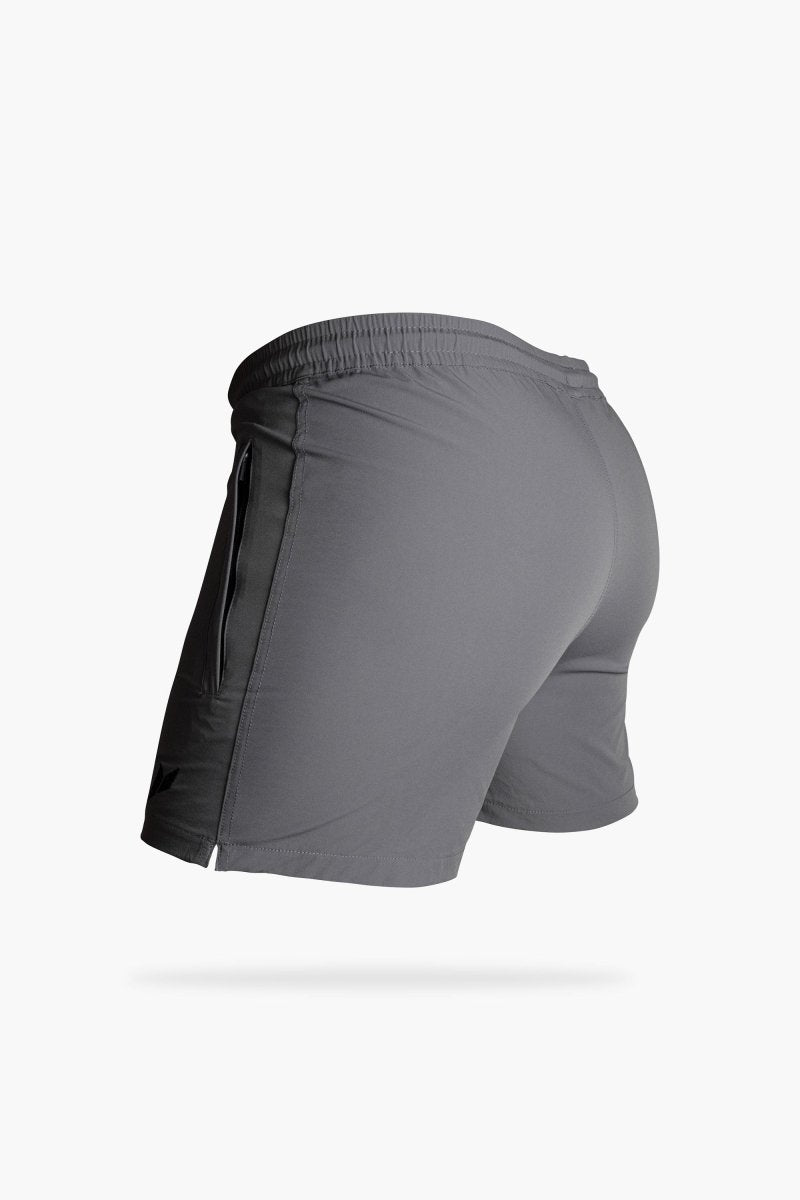 Side profile of fitted men’s gym shorts with split hem and elastic waistband for training