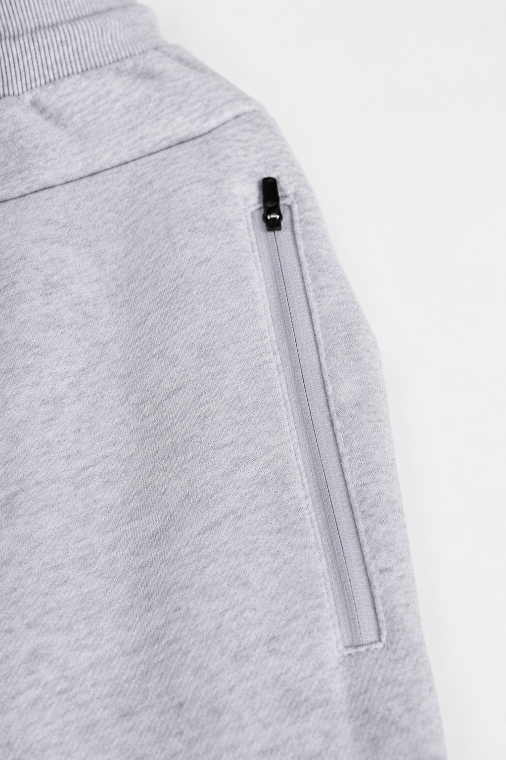 Zuva Grey Track Pants zip pocket detail — secure black zip side pocket on ash grey marl heavyweight fleece mens athletic track pants
