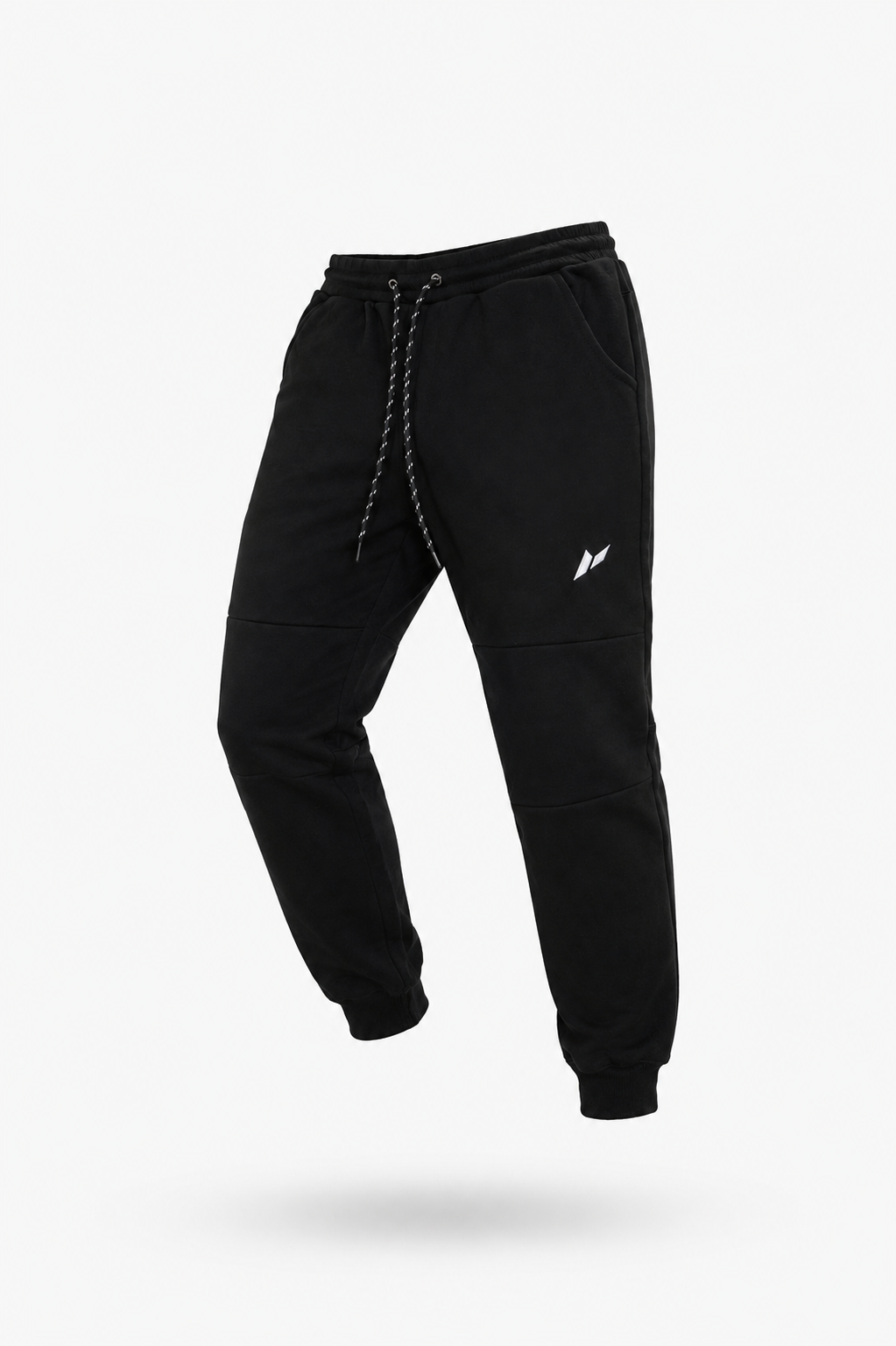 Zuva Black Track Pants angled product shot — black heavyweight fleece with speckled drawstring waistband, white embroidered Zuva icon and ribbed cuffed ankles